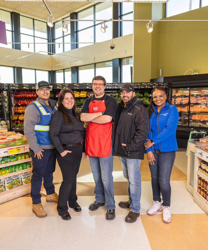 a group of people standing in a grocery store