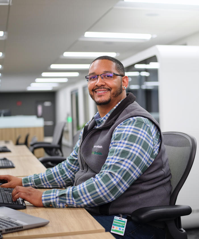 a man sitting at a desk with a computer