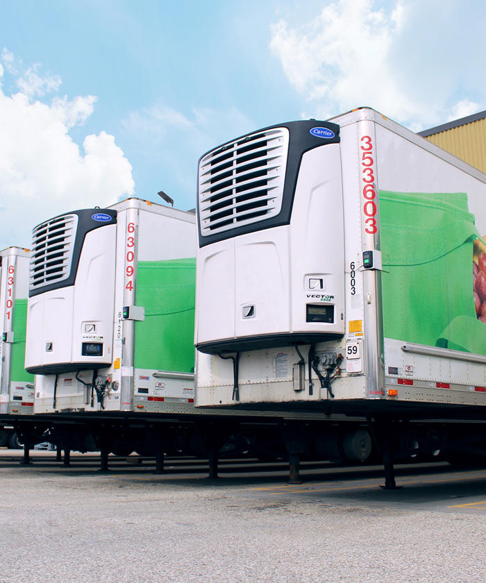 a row of SpartanNash semi trucks parked in a parking lot