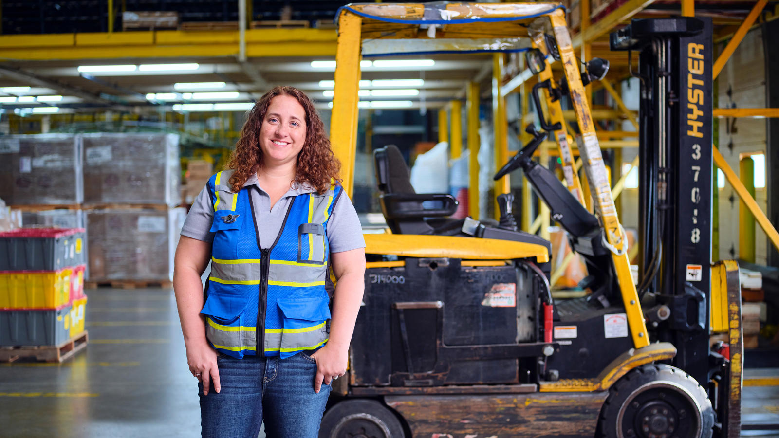 a woman standing in a warehouse