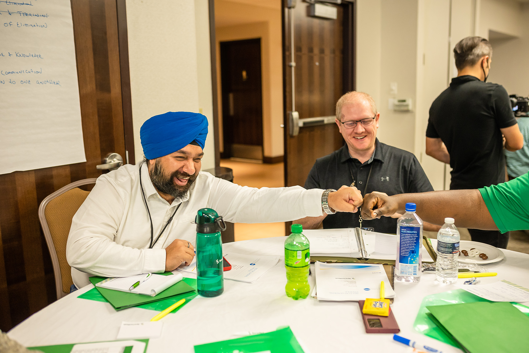a group of men sitting at a table in a Propel class