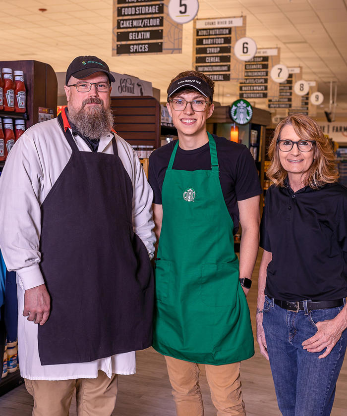 a group of people standing in the Knapp Corners D&W Market