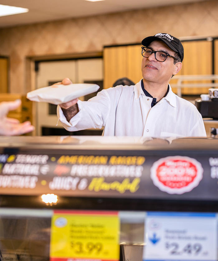 a man holding a package in a deli