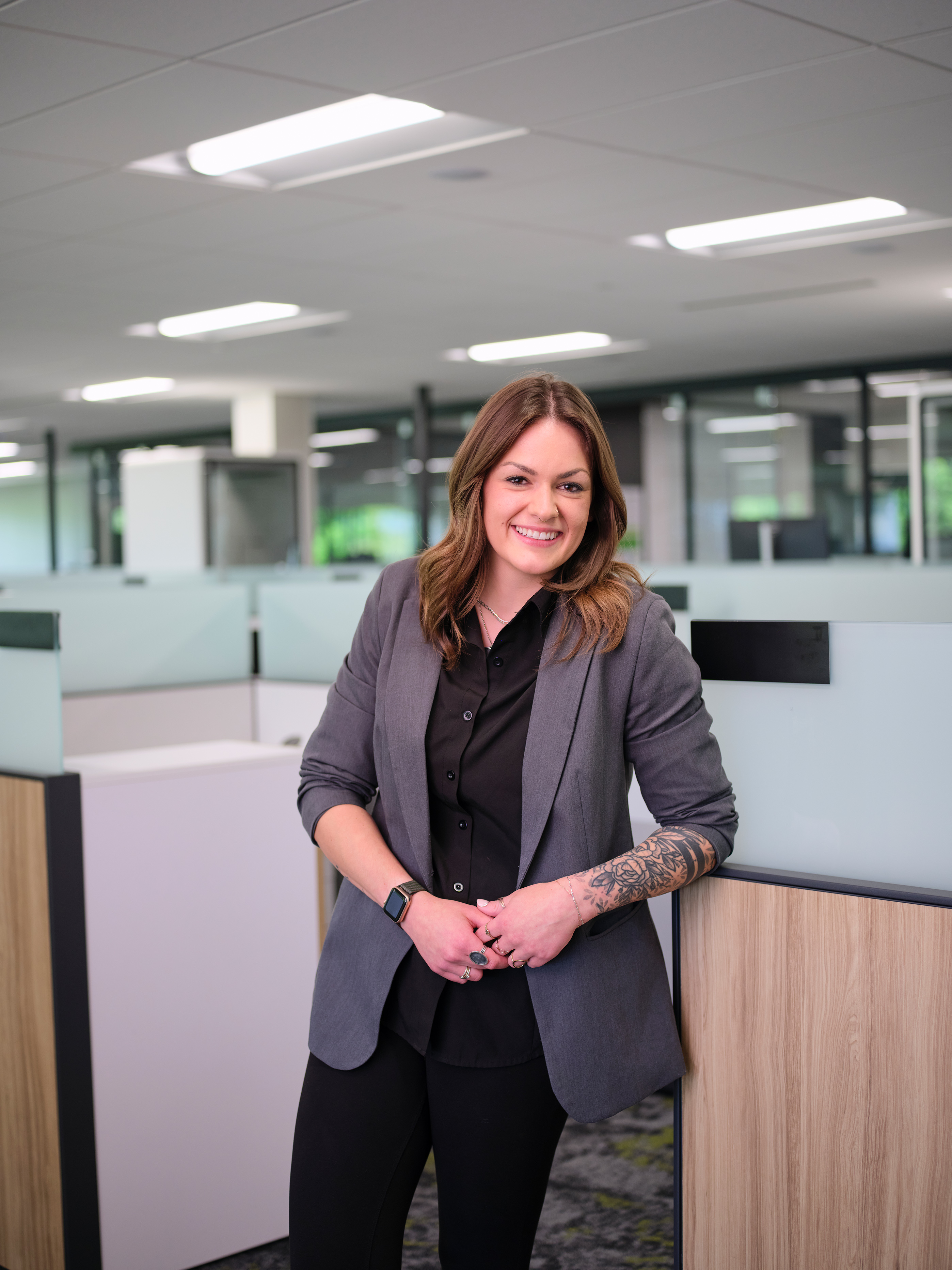a woman in a suit standing in an office