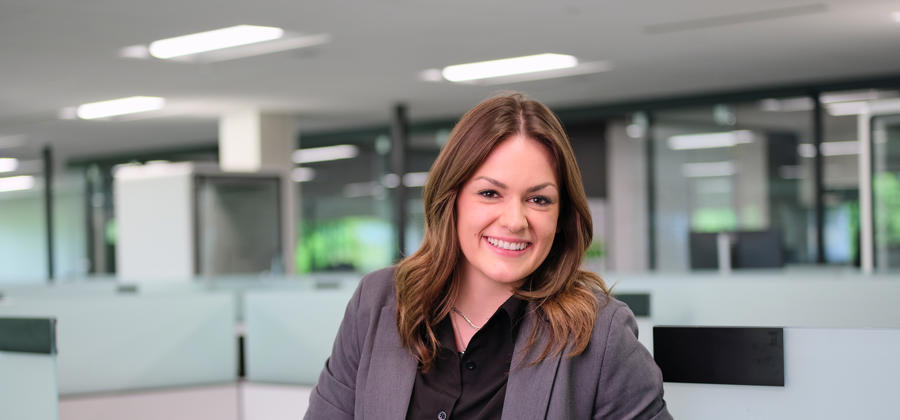 a woman in a suit standing in an office