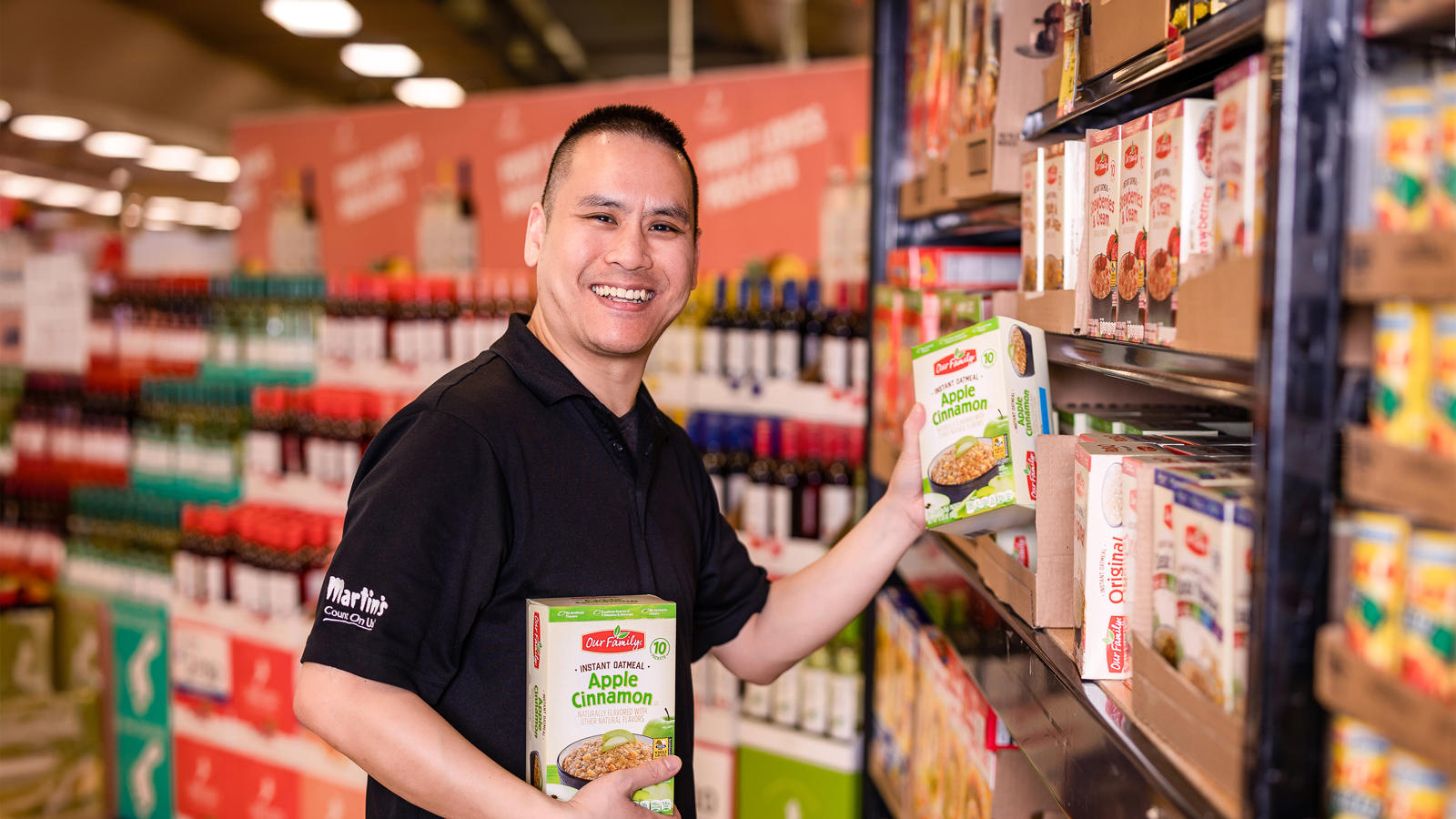 a man holding a box of cereal