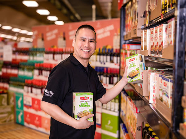 a man holding a box of cereal