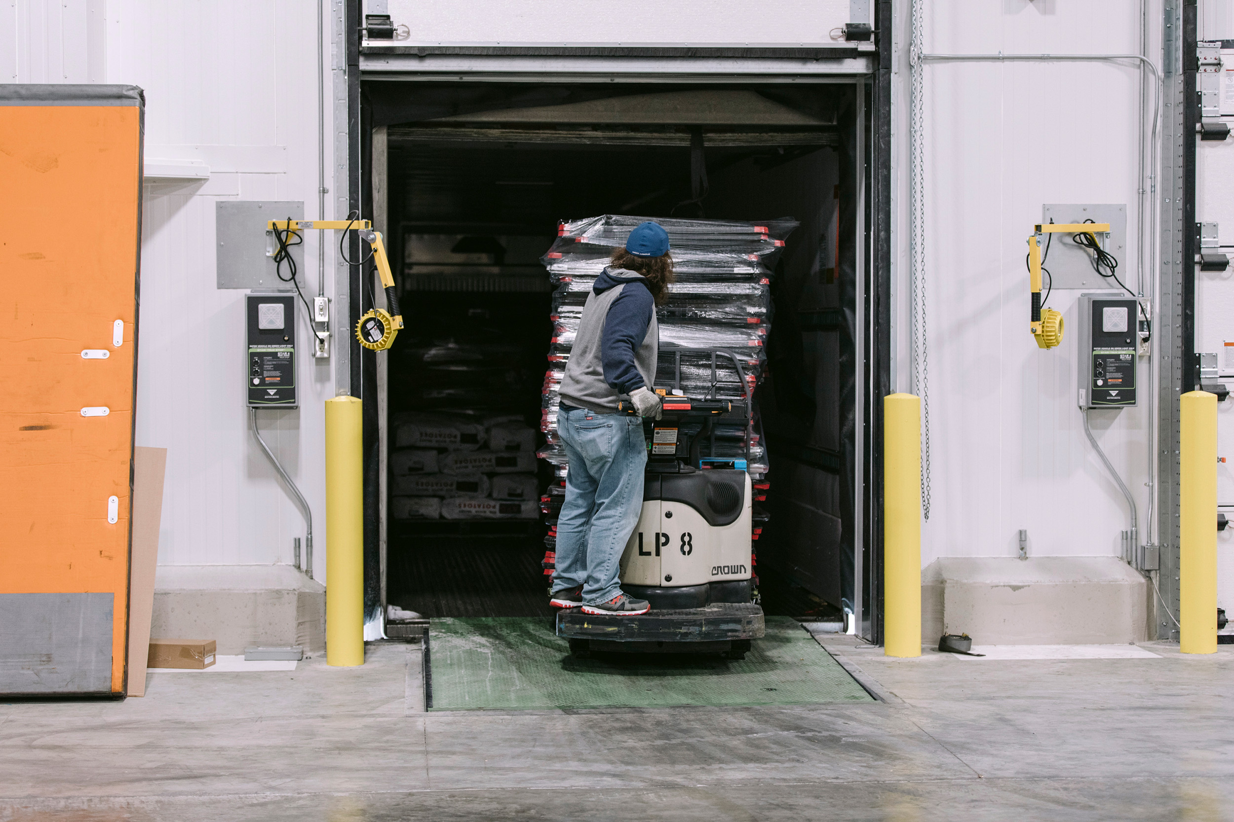 a man standing on a machine in a warehouse