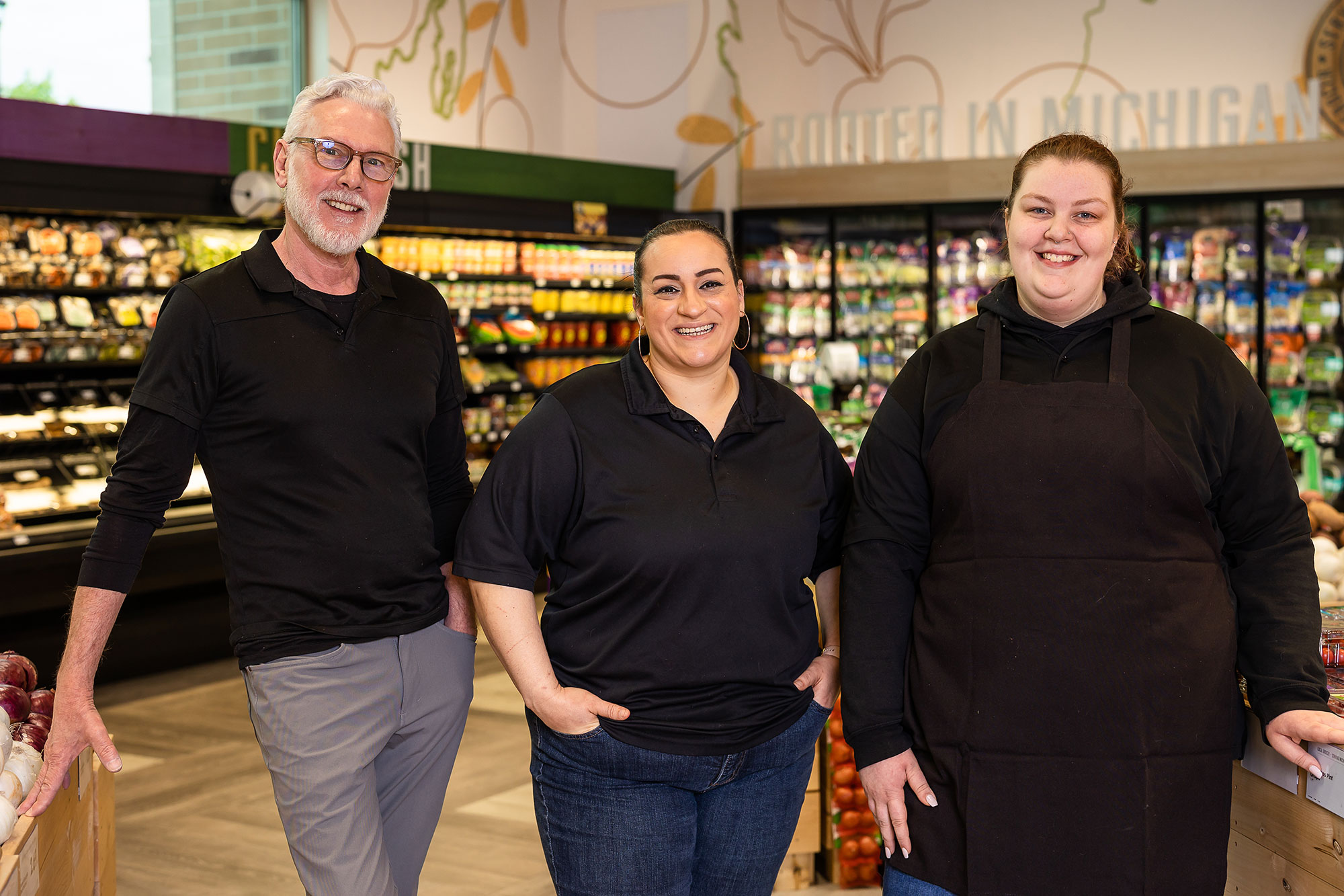 a group of people standing in a grocery store