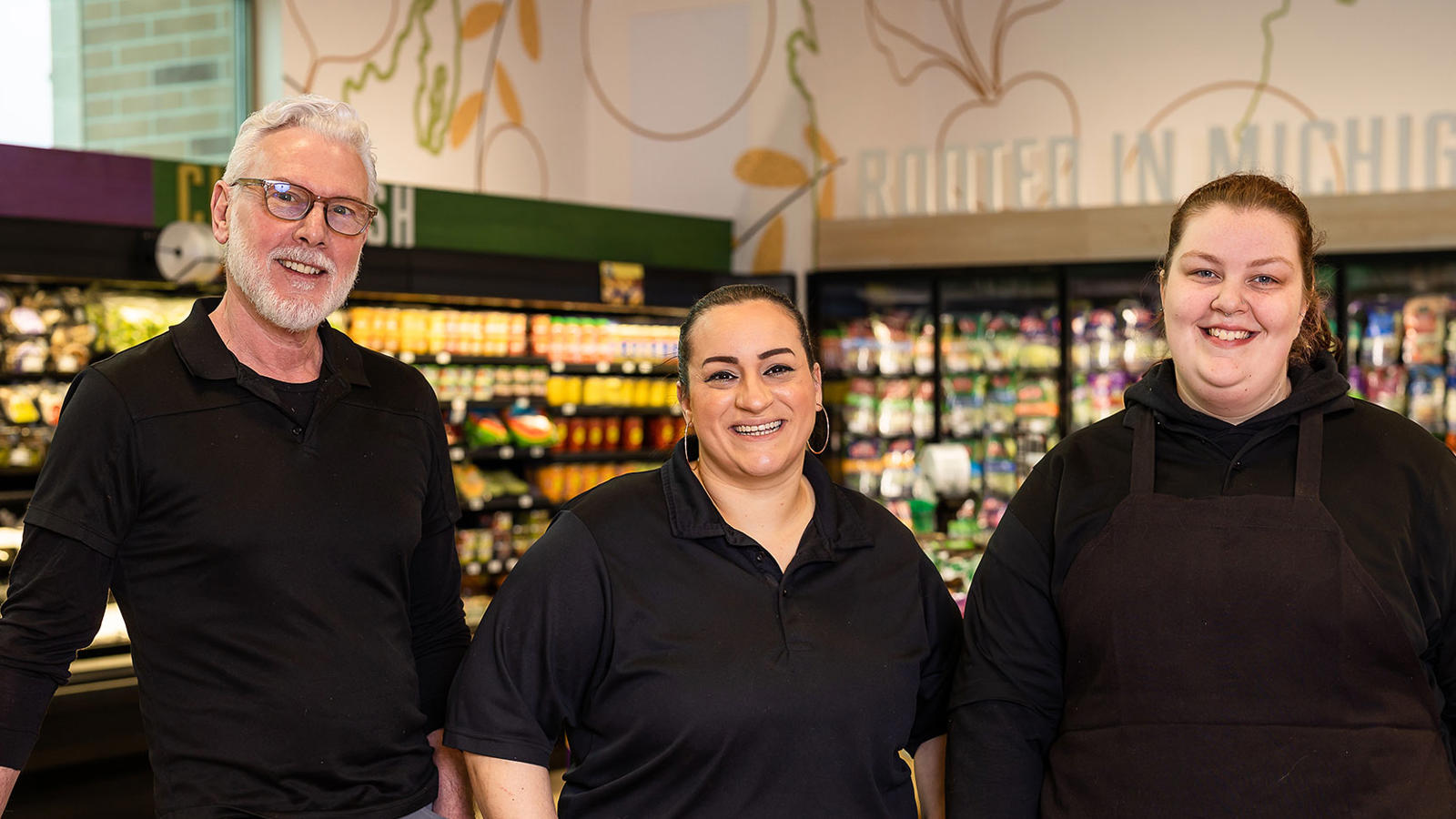 a group of people standing in a grocery store