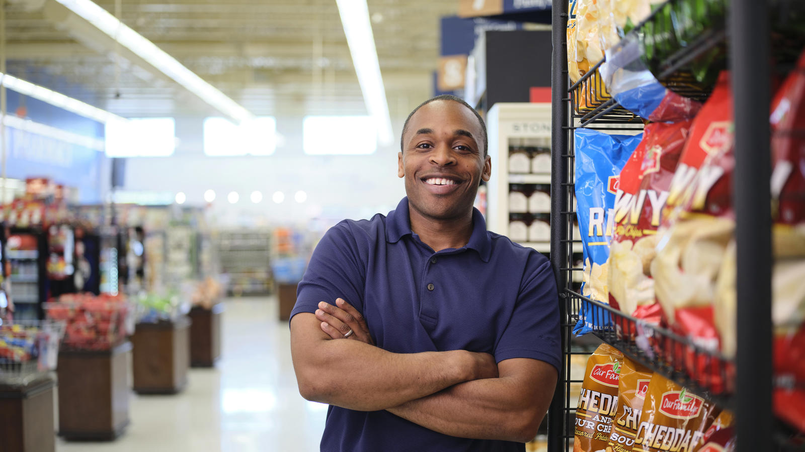 a man standing in a store with his arms crossed