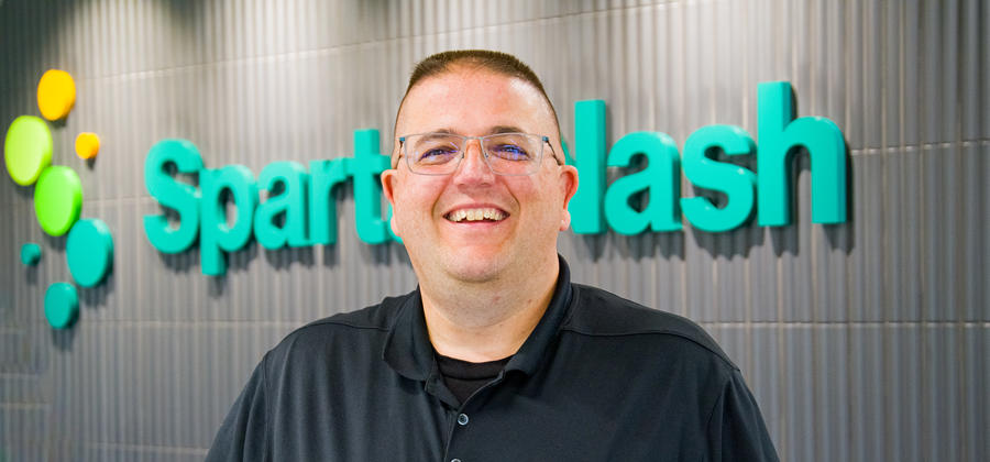 a man wearing glasses smiling
