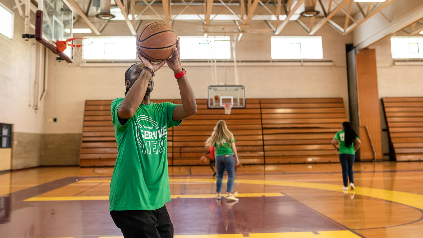 a man holding a basketball in a gym