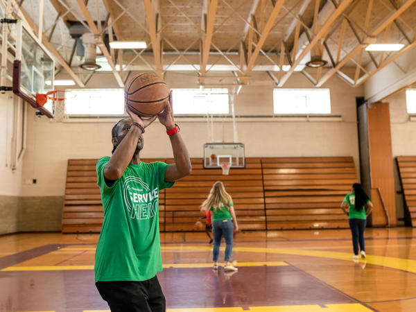 a man holding a basketball in a gym