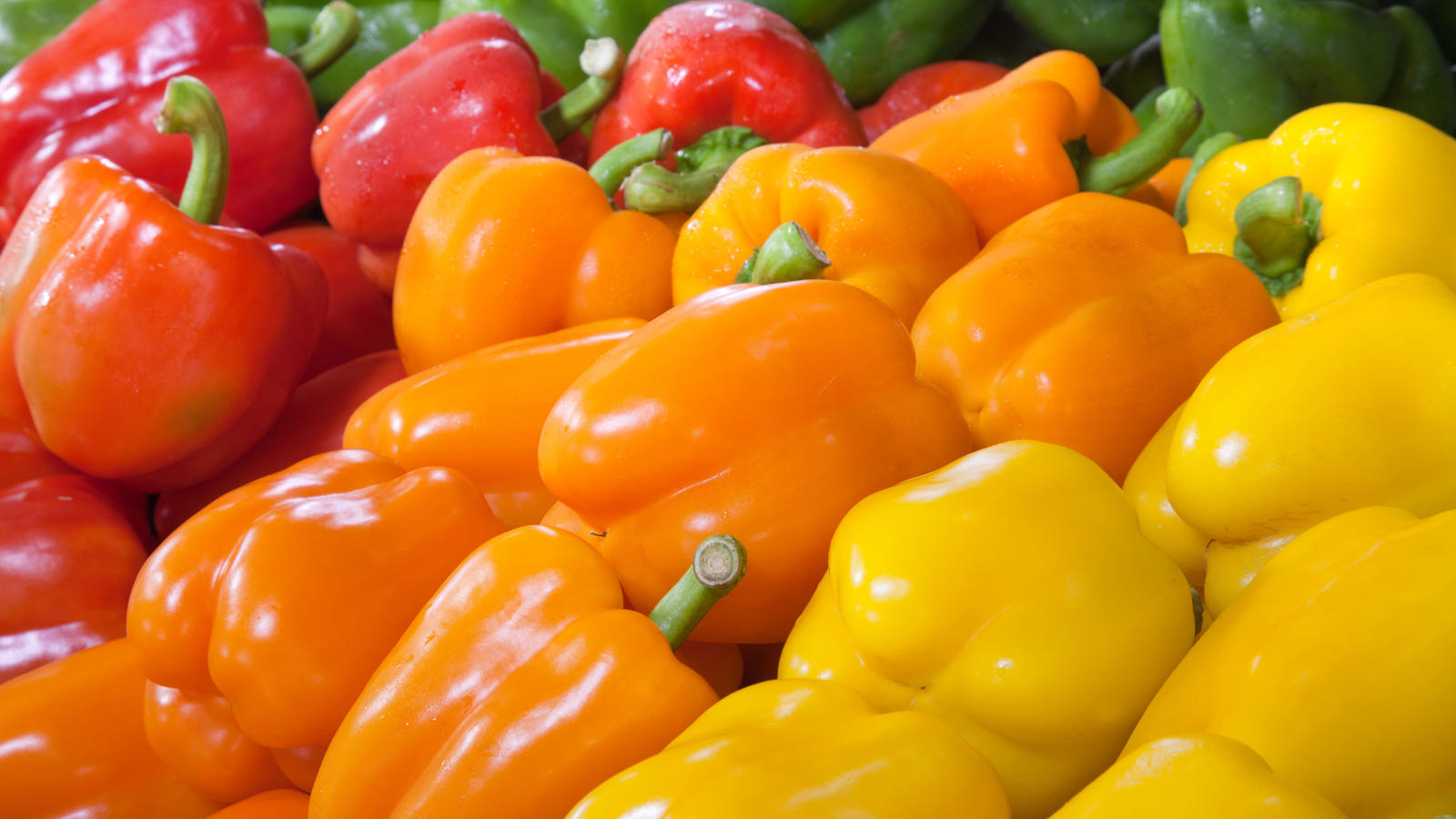 a pile of tricolo peppers in a grocery store