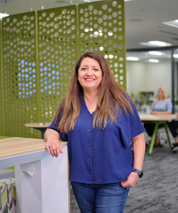 a woman standing next to a table