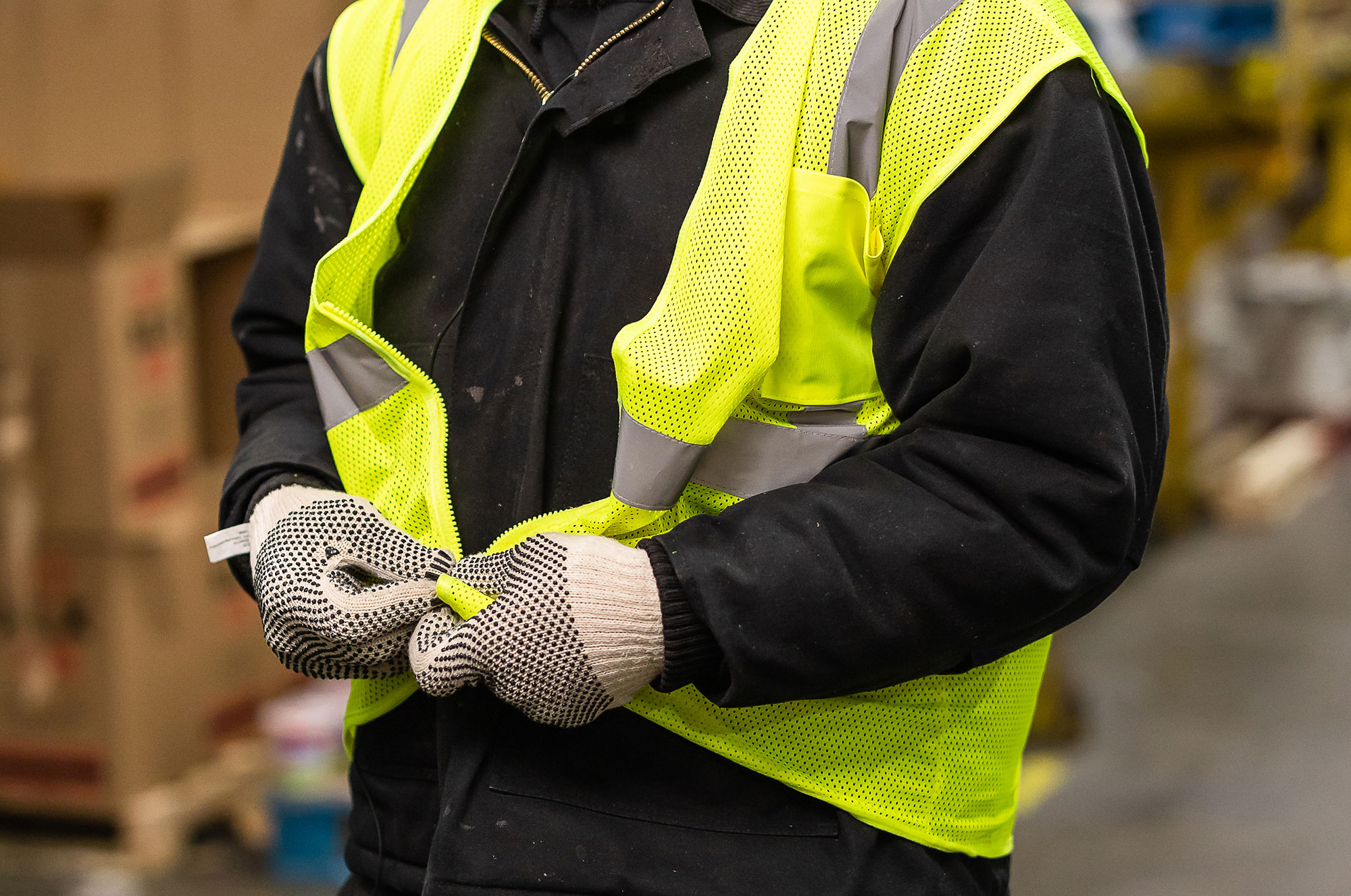 a person wearing a safety vest and gloves